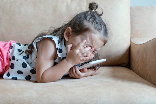 Frustrated child with tablet.