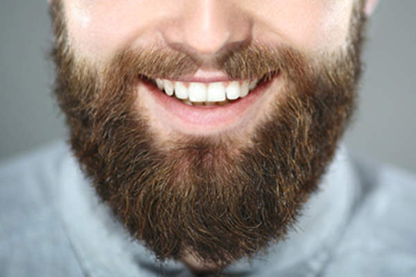 Bearded man smiling.
