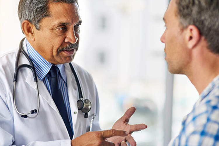 doctor talking to middle aged man about revascularization