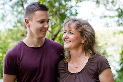 Mother smiling at her teenage son.