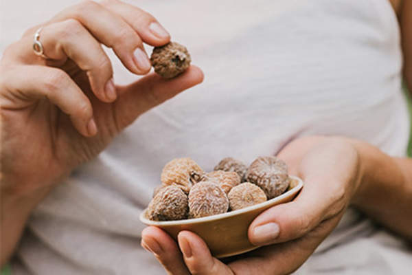Woman eating dried figs.