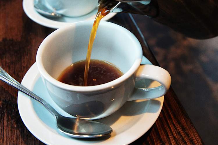 Pouring a cup of coffee.