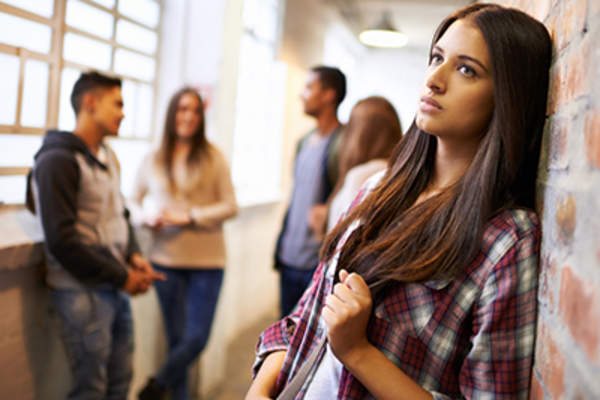 Woman separated from a group of people while feeling depressed.