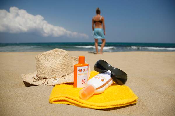 Hat sunscreen and sunglasses on beach.