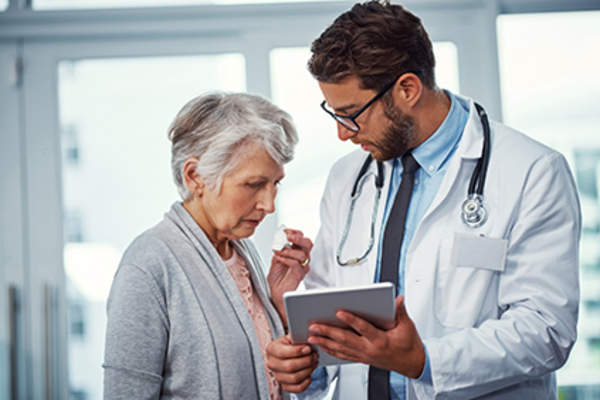 Doctor explaining the potential side effects of adjuvant therapy to a patient.