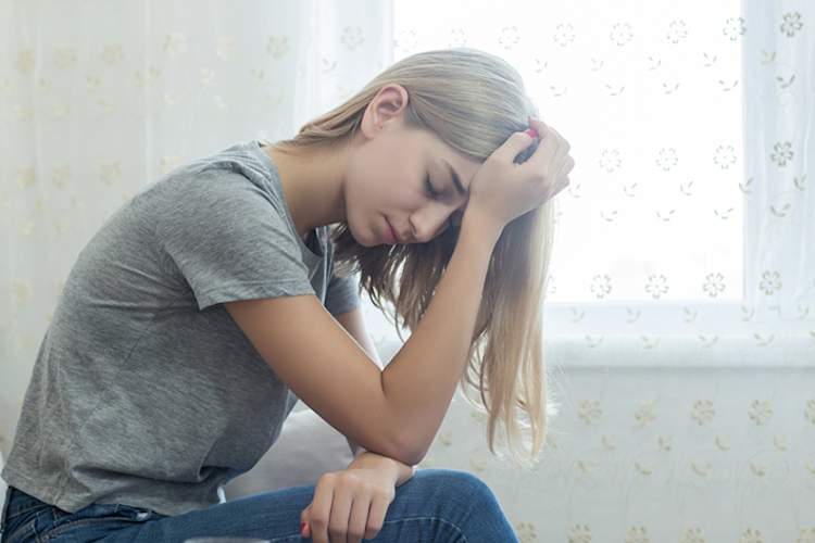 Young woman with a migraine headache.