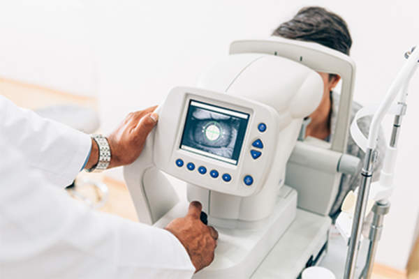 Eye doctor performing eye exam.
