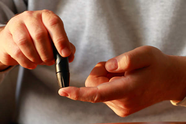 Man with type 1 diabetes checking blood sugar.
