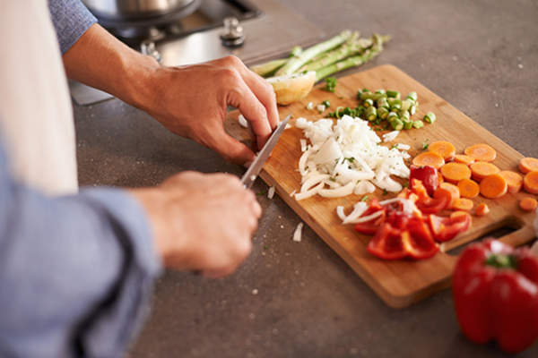 man cutting up veggies image