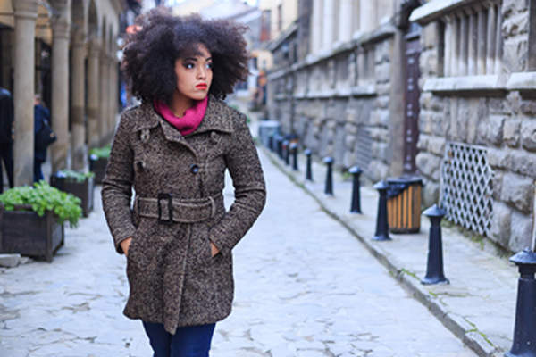 Stylish woman wearing a coat and sweater in the winter.