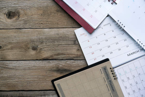 Calendars and day planners on table.