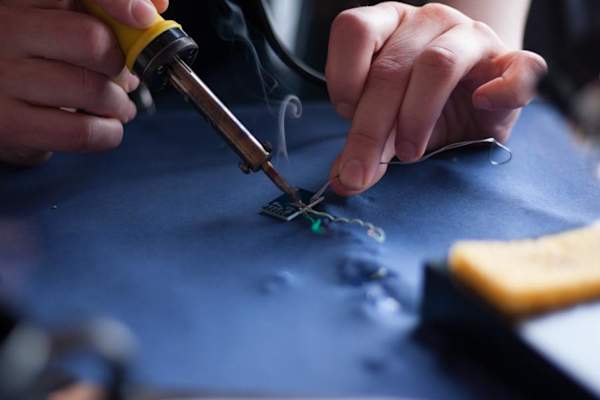 hands repairing SIM card with tools