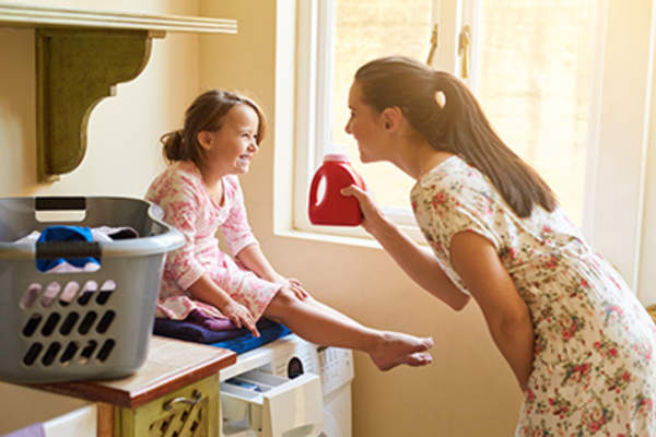 Mom and daughter having fun in the laundry room.