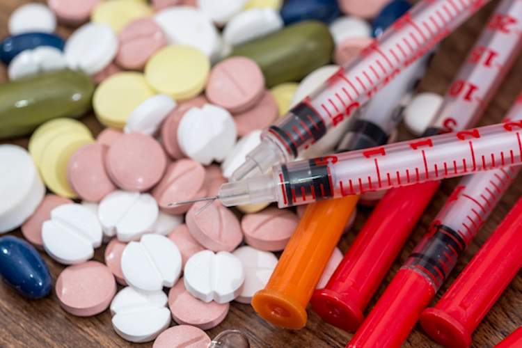 Pills and insulin syringes.