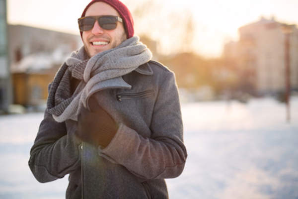 Man outside in winter wearing sunglasses.