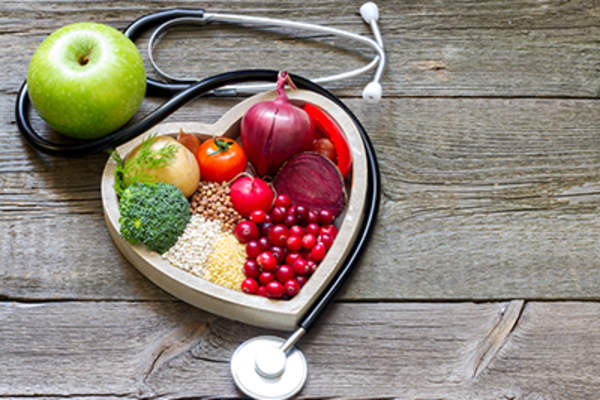 Healthy food in heart and stethoscope.