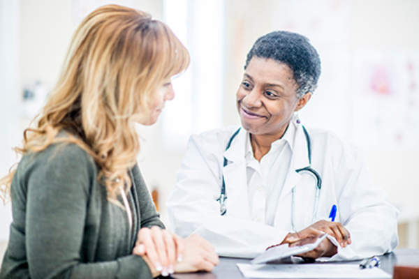 Woman talking to her doctor.