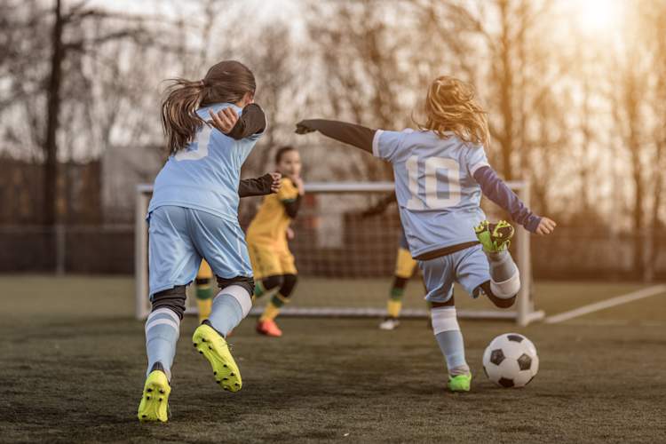 Young girls playing soccer.