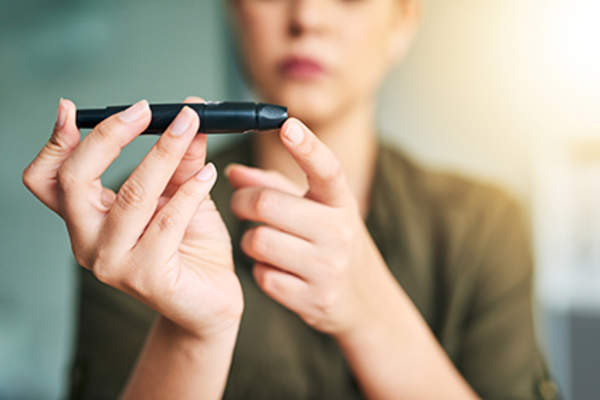 Diabetic woman checking her blood sugar levels.