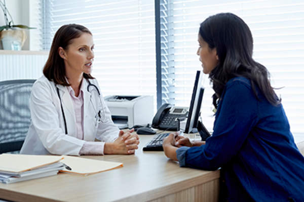 Doctor and patient discussing osteoporosis treatment.