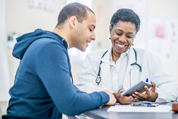 Man discussing treatments with his doctor.
