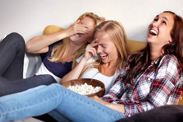 Laughing at hilarious film with friends.
