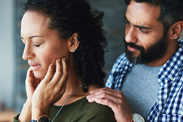Man supporting woman in pain.
