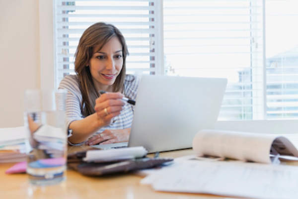 Woman researching at home on computer.