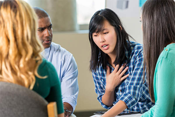 Young woman talking in therapy.