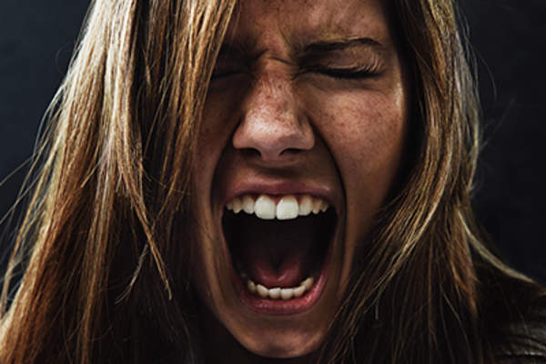Angry young woman shouting.