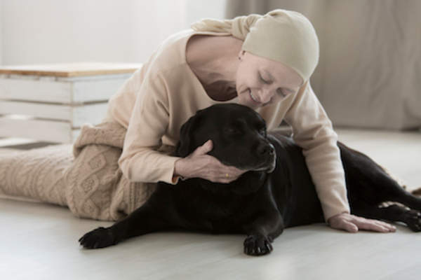 Relaxing with dog to reduce stress.