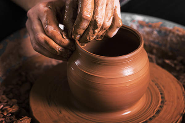 Making a bowl on a pottery wheel.