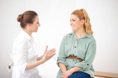 Dermatologist explaining psychodermatology to patient.