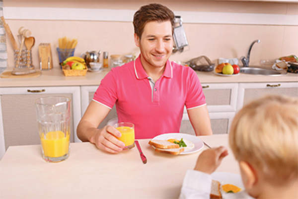 Father having breakfast with his young son.