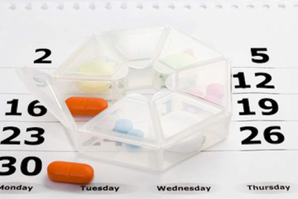 Daily pill container on calendar.