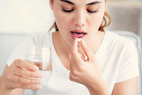 Woman taking her medication.