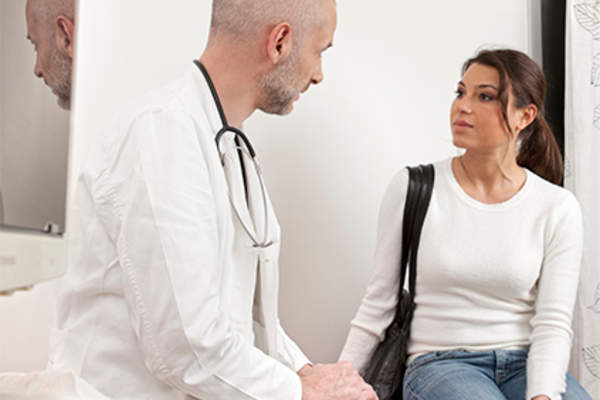 Young woman having a conversation with her doctor.