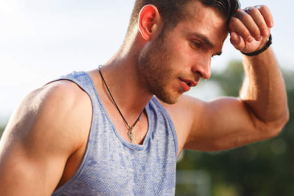 Man sweating profusely on hot day.