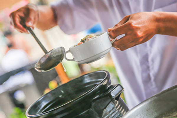 Chef serving hot soup
