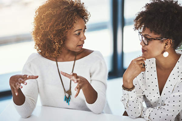 Woman expressing an idea to a friend.