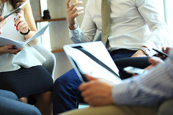 People sitting in a conference together and taking notes
