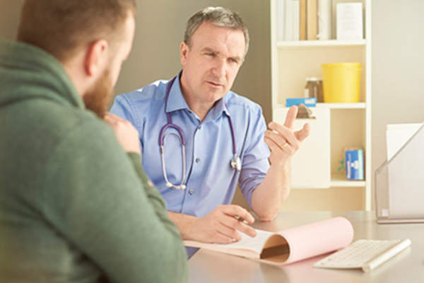 Doctor referring to his computer