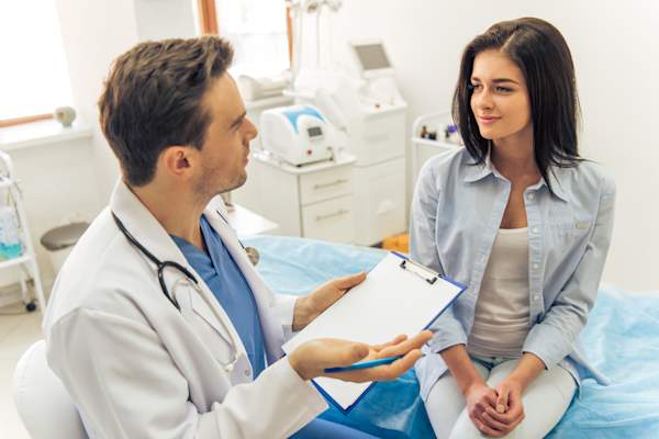 Woman at the doctor talking to doctor