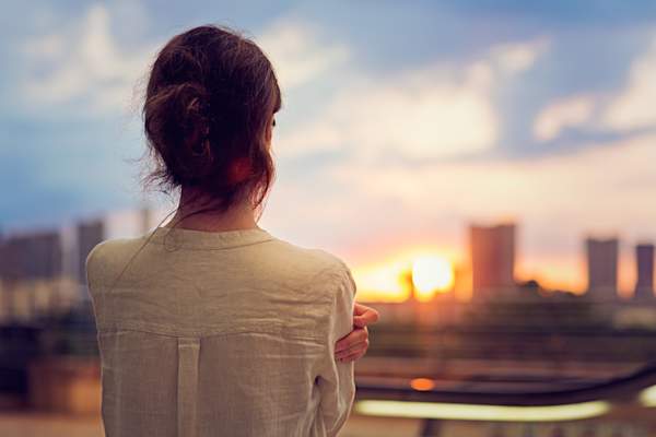 Woman watching sunset image.