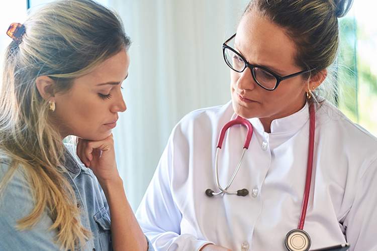 Anxious woman talking to her doctor.