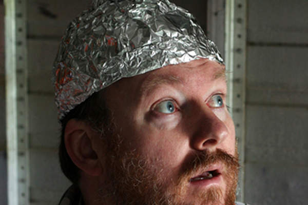 Conspiracy theorist wearing a tin foil hat.