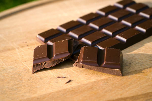 Dark chocolate bar with pieces broken off