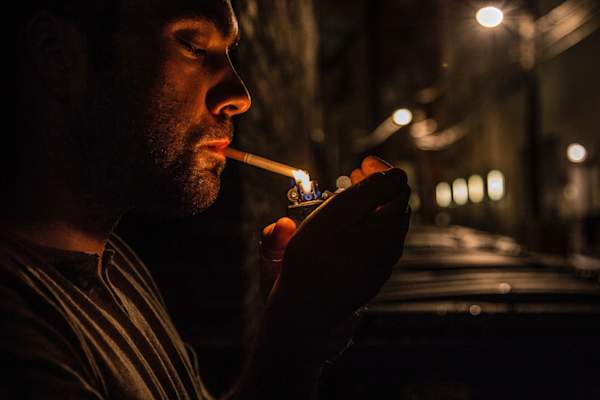 man lighting cigarette