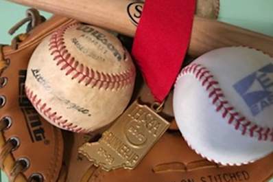 Baseballs, a baseball bat, and a medal.