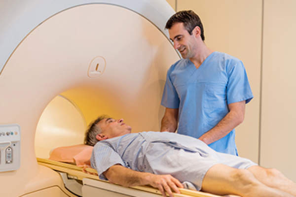 Radiologist talking to a mature patient at MRI scan